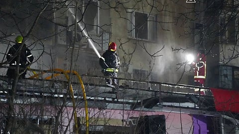 Emergency services personnel work to extinguish a fire following a Russian attack in Odesa, Ukraine, Wednesday, Dec. 31, 2025.