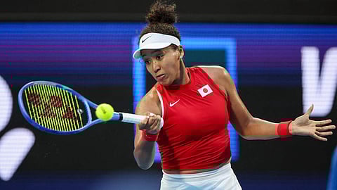 Naomi Osaka returns a shot to Maria Sakkari during their United Cup tie