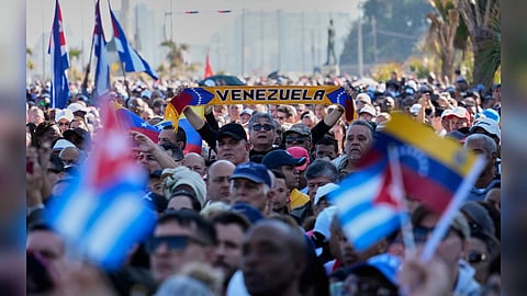 People gather holding Venezuelan flags at a public demonstration