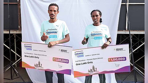 Tsegaye Molla, Senait Kefelegn Lesharge with their cheques
