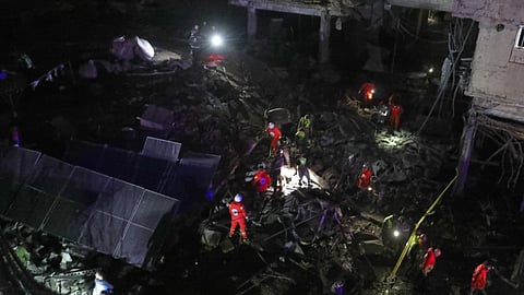 Lebanese Red Cross volunteers search for possible victims in a building destroyed by an Israeli airstrike in the southern port city of Sidon, Lebanon