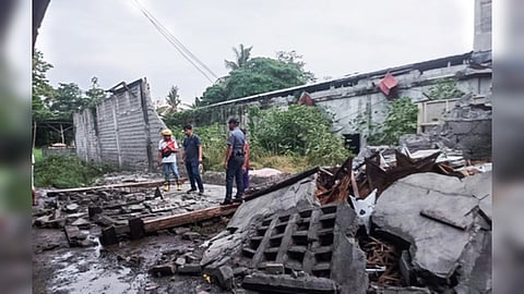 Residents inspect debris after a 6.7 quake off Mindanao Island.