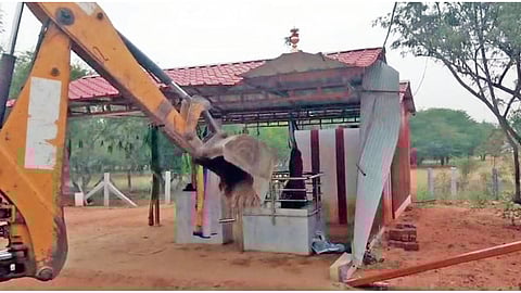 Earthmover in action on a poramboke land near Perumanallur