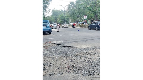 Loose gravel surface at the 67th Cross Street junction on 11th Avenue in Ashok Nagar