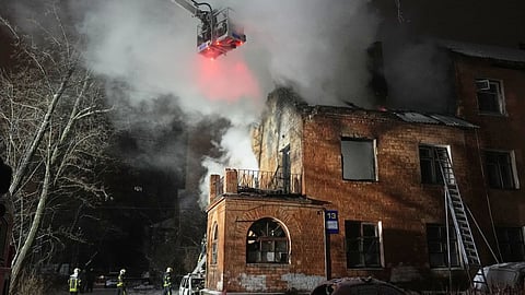 Rescue workers put out a fire at a residential building damaged by a Russian strike in Kyiv, Ukraine, Friday, Jan. 9, 2026.