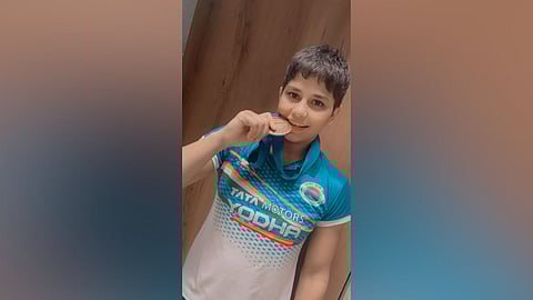 Indian wrestler Antim Panghal poses for a picture with a medal.