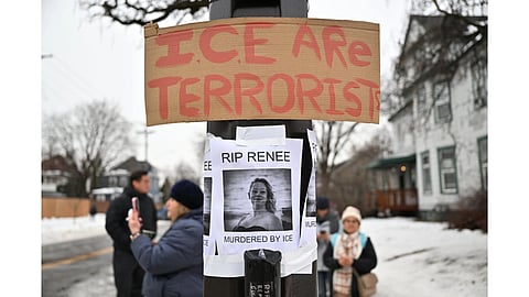 People gather around a makeshift memorial honoring the victim of a fatal shooting involving federal law enforcement agents, near the site of the shooting in Minneapolis.