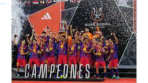 Barcelona players celebrate after winning the Spanish Super Cup final soccer match against Real Madrid at King Abdullah Sports City Stadium in Jeddah, Saudi Arabia.