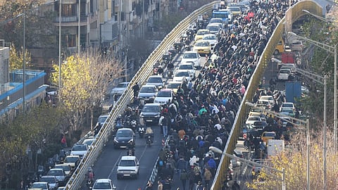 Protesters march on a bridge in Tehran, Iran