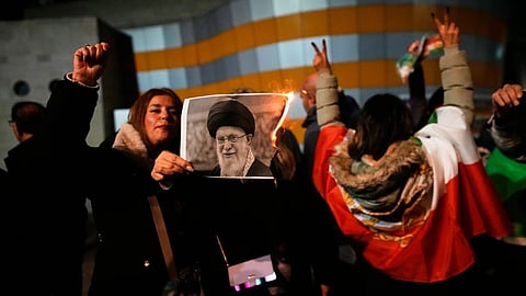 Demonstrators burn a poster depicting Iran’s Supreme Leader Ayatollah Ali Khamenei during a rally in support of anti-government protests in Iran, in Holon, Israel Wednesday, Jan. 14, 2026