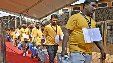 Polling officials carry electoral material during the counting of votes after the Maharashtra municipal corporation elections, in Sangli district, Friday, Jan. 16, 2026
