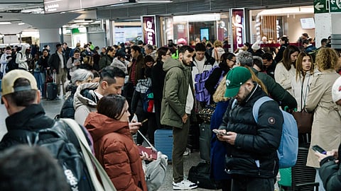 Passengers wait in the hall of Madrid train station