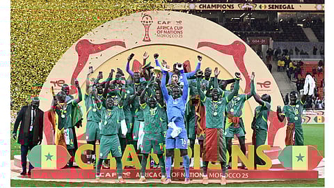 Senegal players celebrate with the trophy