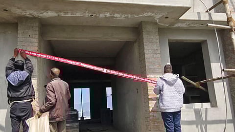 Officials seal an unauthorised building in Ooty