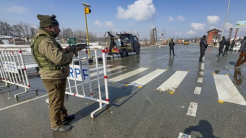 Security personnel keep vigil at the Jammu-Srinagar national highway ahead of Republic Day celebrations, near Wanpoh, in Kulgam district, Jammu and Kashmir