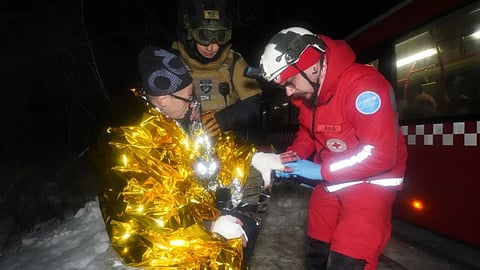 A paramedic gives first aid to a resident who was injured in a Russian airstrike in Kharkiv, Ukraine, Saturday, Jan. 24, 2026