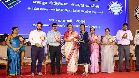 Chief Electoral Officer Archana Patnaik handing over an ID card to a new voter at the National Voters’ Day celebrations in Chennai on Sunday