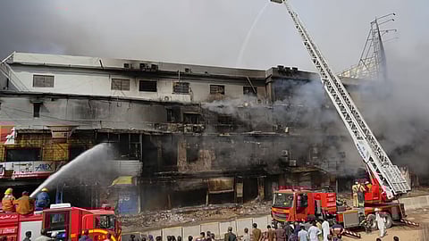 Firefighters try to control a massive fire that was broke out in a multi-story shopping mall in overnight, in Karachi, Pakistan