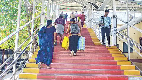 Passengers climbing the steep flight of stairs at the main entrance of the St Thomas Mount railway station