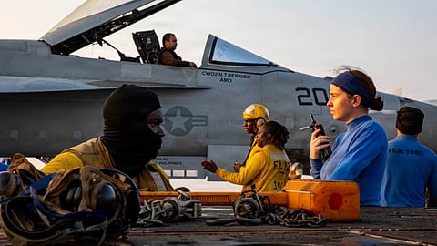 This handout photograph from the U.S. Navy shows sailors taxiing an F/A-18E Super Hornet on the flight deck of the Nimitz-class aircraft carrier USS Abraham Lincoln in the Indian Ocean on Jan. 25, 2026.