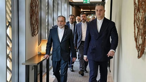 Iranian Foreign Minister Abbas Araghchi, (L) heads to venue for talks between Iran and the U.S., in Muscat, Oman.