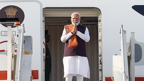 Prime Minister Narendra Modi waves as he emplanes for a two-day trip to Malaysia, in New Delhi