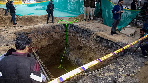 A 15-foot-deep pit dug for sewage work by the Delhi Jal Board (DJB), where a motorcyclist died after falling, barricaded during investigation by police, at Janakpuri area