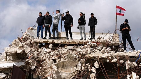 People gather as Lebanese Prime Minister Nawaf Salam tours areas in southern Lebanon along the border with Israel that the Lebanese army says it has been cleared of the armed presence of the militant Hezbollah group, in the village of Yarine