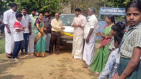 Madhanpattavur Panchayat Union Primary school headmaster Elamathiyan receiving the vehicle from the donors in Thanjavur on Monday