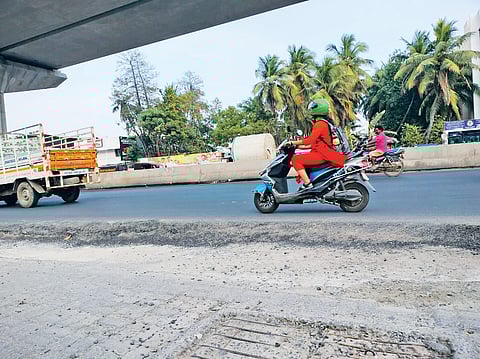 The newly relaid road rising six inches off the ground on OMR