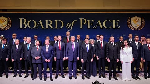 President Donald Trump stands with other World leaders before a Board of Peace meeting at the U.S. Institute of Peace in Washington.
