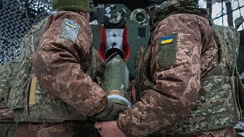 Ukrainian servicemen load an artillery shell before firing at Russian positions on the front line in Kharkiv region of Ukraine.