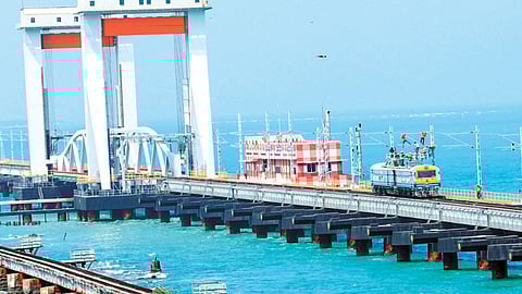 Technicians descaling power lines on the Pamban new rail bridge
