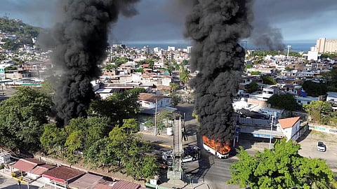 Smoke billows from burning vehicles amid a wave of violence, following a military operation in which a government source said Mexican drug lord Nemesio Oseguera, known as "El Mencho," was killed, in Puerto Vallarta, Jalisco, Mexico, on February 22, 2026
