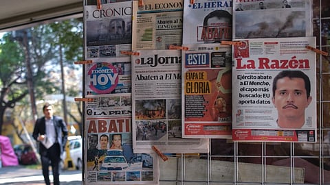Newspapers hang on display for sale in Mexico City, Monday, Feb. 23, 2026, a day after the Mexican army killed Jalisco New Generation Cartel leader Nemesio Oseguera Cervantes, known as “El Mencho.”