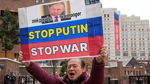 A South Korean protester holds a banner to denounce Russia's invasion of Ukraine on the fourth anniversary of the Russia-Ukraine war, near the Russian Embassy in Seoul, South Korea, Tuesday, Feb. 24, 2026. A banner reads "Victory will be ours."