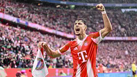 Bayern Munich's Aleksandar Pavlovic celebrates scoring during the Bundesliga soccer match between Bayern Munich and Eintracht Frankfurt in Munich, Germany.