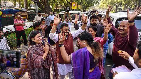 AAP members celebrate after the party's national convener Arvind Kejriwal and party leader Manish Sisodia were discharged by a Delhi court in a liquor policy case, in New Delhi, Friday, Feb. 27, 2026.