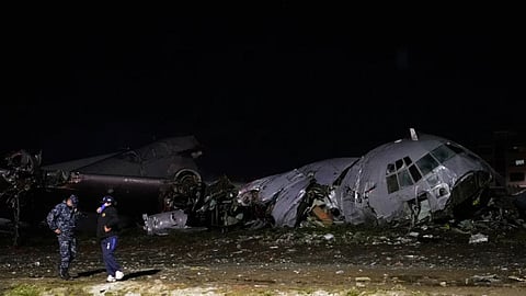 Police stands next to a plane that crashed in El Alto, Bolivia, Friday, Feb. 27, 2026