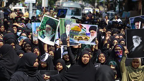 Shia Muslims and supporters of Iranian leader Ali Khamenei hold placards and banners on Peters Road in Royapettah, Chennai