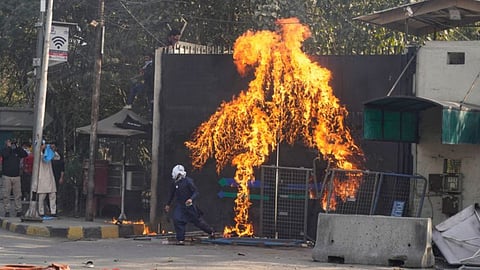 Shiite Muslims set a fire at the US Consulate's entrance gate during a rally to condemn the killing of Iranian Supreme Leader Ayatollah Ali Khamenei, in Lahore, Pakistan, Sunday, March 1, 2026.