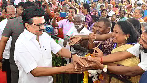 Chief Minister MK Stain with beneficiaries of the housing scheme in Saidapet on Monday