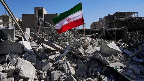 An Iranian flag is placed among the ruins of a police station struck Monday during the U.S.–Israeli military campaign in Tehran, Iran