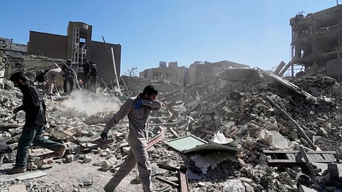 A group of men inspects the ruins of a police station struck Monday amid the U.S.–Israeli military campaign in Tehran, Iran