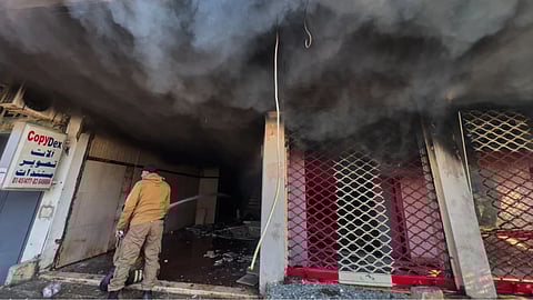 A firefighter extinguishes fire at a building that was hit by an Israeli airstrike in Dahiyeh, a southern suburb of Beirut, Lebanon