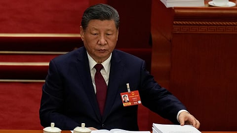 Chinese President Xi Jinping reacts during the opening session of the National People's Congress (NPC) in Beijing.