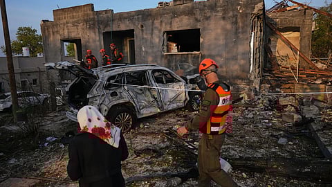Residents and officers from Israel’s Home Front Command inspect a house destroyed by an Iranian missile strike in Zarzir, northern Israel