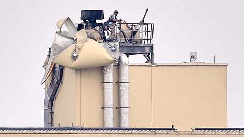 U.S. embassy personnel inspect the damage caused by a bombing in Baghdad, Saturday, March 14, 2026