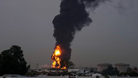 Fire and plumes of smoke rises after a drone struck a fuel tank forcing the temporary suspension of flights. near Dubai International Airport, in United Arab Emirates