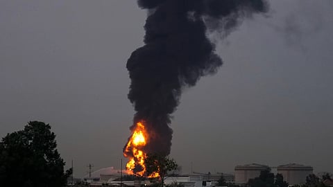 Fire and plumes of smoke rises after s drone struck a fuel tank forcing the temporary suspension of flights. near Dubai International Airport, in United Arab Emirates